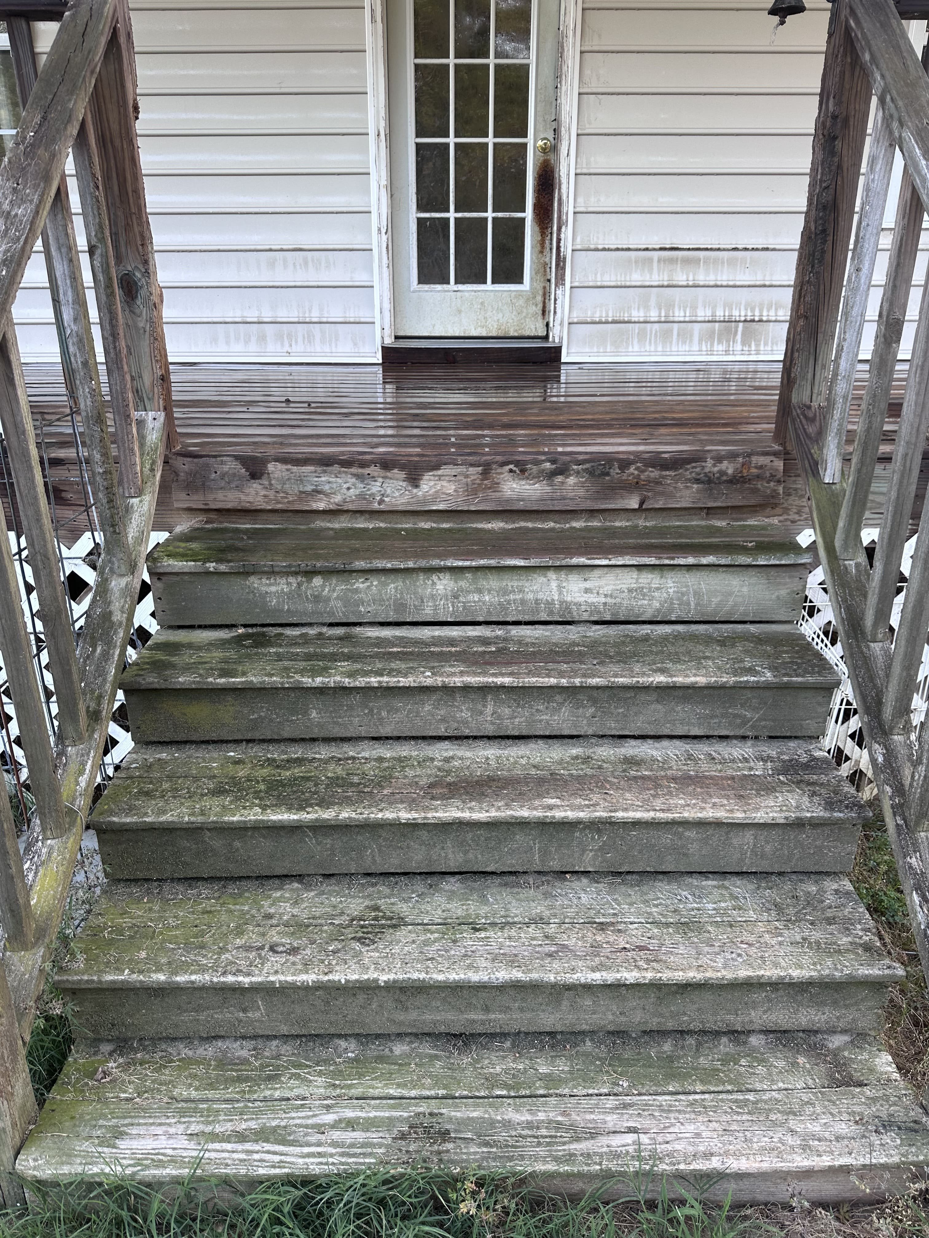 Dirty driveway and siding before pressure washing